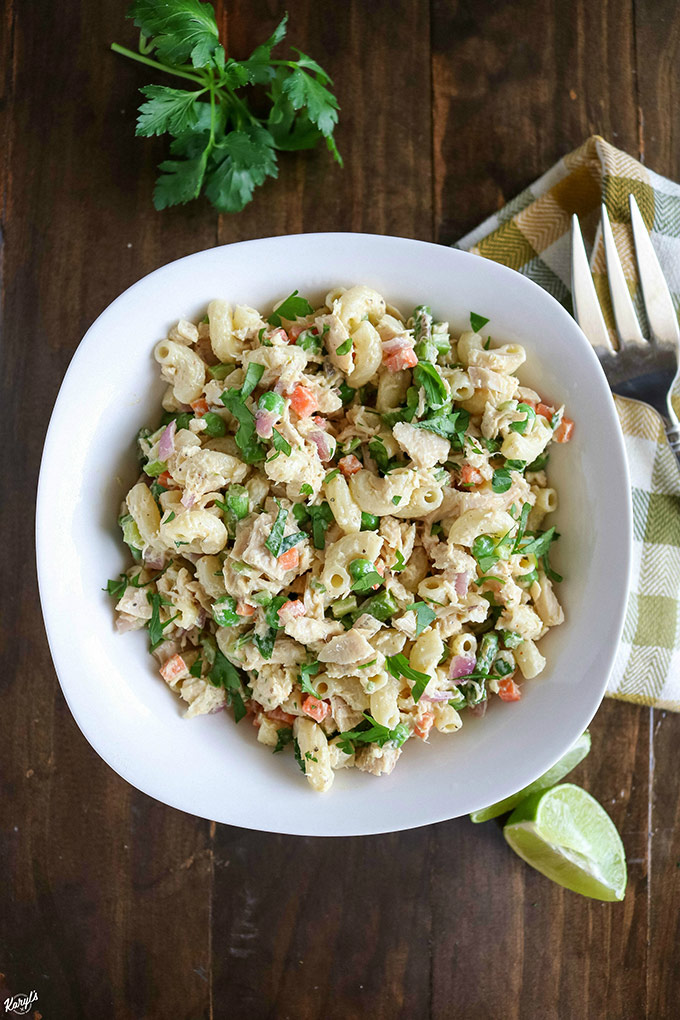 overhead shot of finished tuna pasta salad in a white bowl with a fork on the side