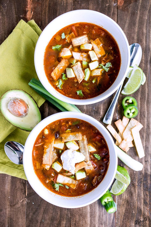 Chicken Tortilla Soup will warm you up with tender chicken, lots of veggies, and a bold kick from the spices. Finish with homemade tortilla strips, diced avocado, a little sour cream and sharp cheese. Ready in under 30 minutes on the stove, or in the crock pot after a long day #chicken #corn #blackbeans #jalapeno #tortillastrips #chickentortillasoup #spicysoup #easyrecipe #comfortfood #karylskulinarykrusade Chicken Tortilla Soup will warm you up with tender chicken, lots of veggies, and a bold kick from the spices. Finish with homemade tortilla strips, diced avocado, a little sour cream and sharp cheese. Ready in under 30 minutes on the stove, or in the crock pot after a long day #chicken #corn #blackbeans #jalapeno #tortillastrips #chickentortillasoup #spicysoup #easyrecipe #comfortfood #karylskulinarykrusade