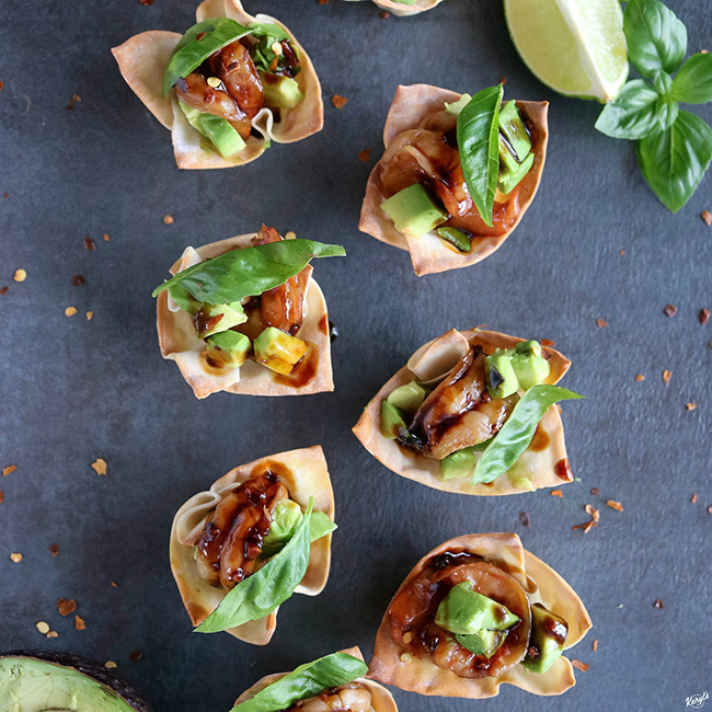 overhead shot of finished wonton cups with lime wedges on the side
