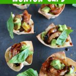 overhead close up shot of finished wonton cups on a black board