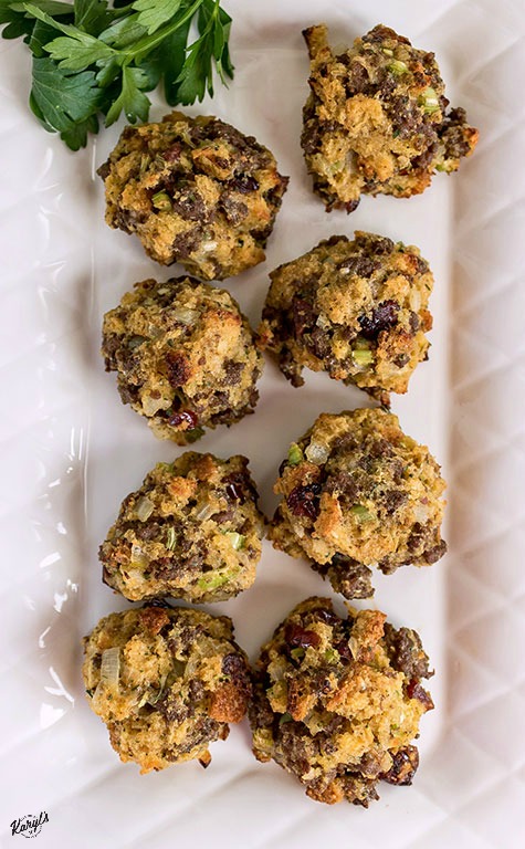 overhead shot of finished venison stuffing balls on a white plate with parsley in the top left hand corner