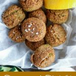 Finished falafel, in a white basket with lemon wedges, cucumber slices & Tzatziki sauce