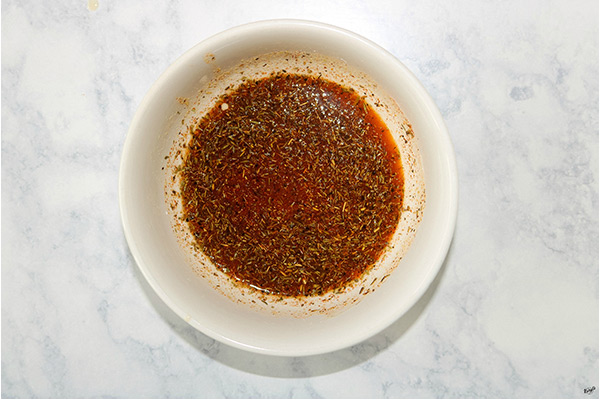 overhead shot of marinade ingredients in a white bowl