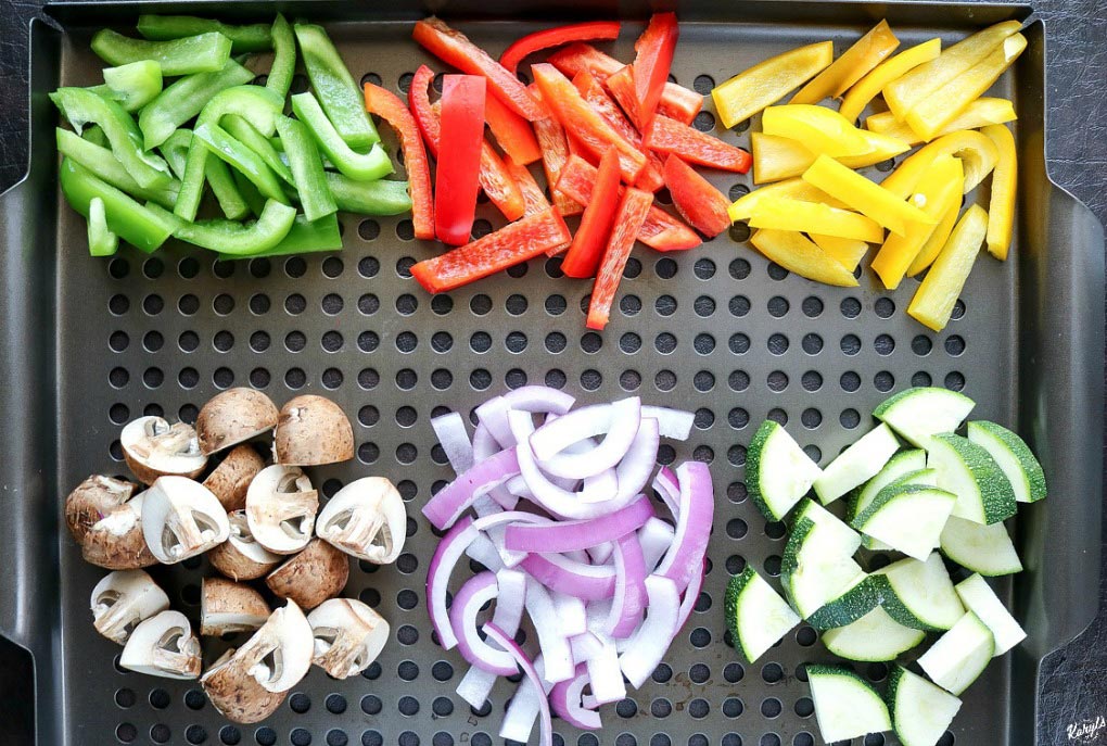 overhead shot of raw vegetables in piles on a grill plate
