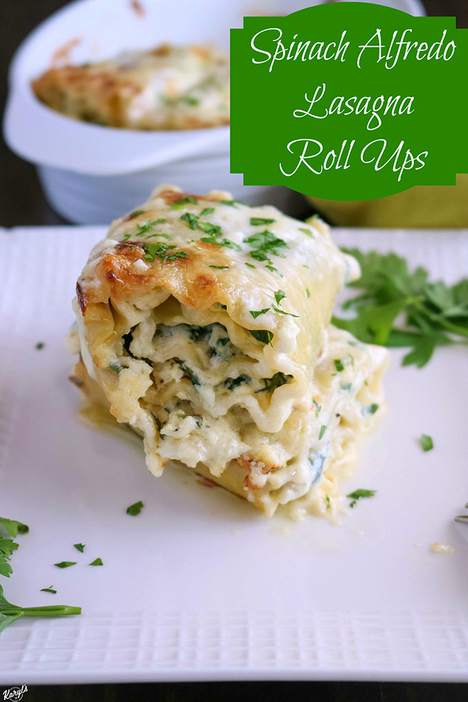 close up shot of finished lasagna roll ups on a white plate, with dish of roll ups in the background