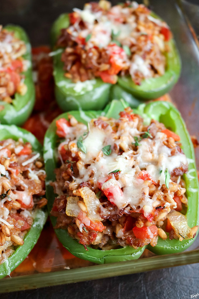 overhead shot of finished Farro Sausage Stuffed Peppers in baking dish