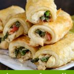 finished Asparagus Prosciutto Puff Pastry stacked on serving dish, open ends showing inside filling