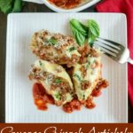 overhead shot of 3 stuffed shells on a white plate with a fork on the side