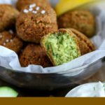close up shot of finished Falafel in a metal bowl with one piece broken in half