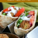 close up shot of 2 Falafel sandwiches with a bowl of Falafel on the side