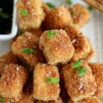 close up shot of a pile of Pan Fried Tofu on a white plate