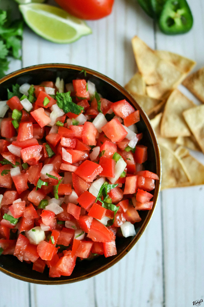 off-center shot of finished Pico de Gallo, with chips in top right corner