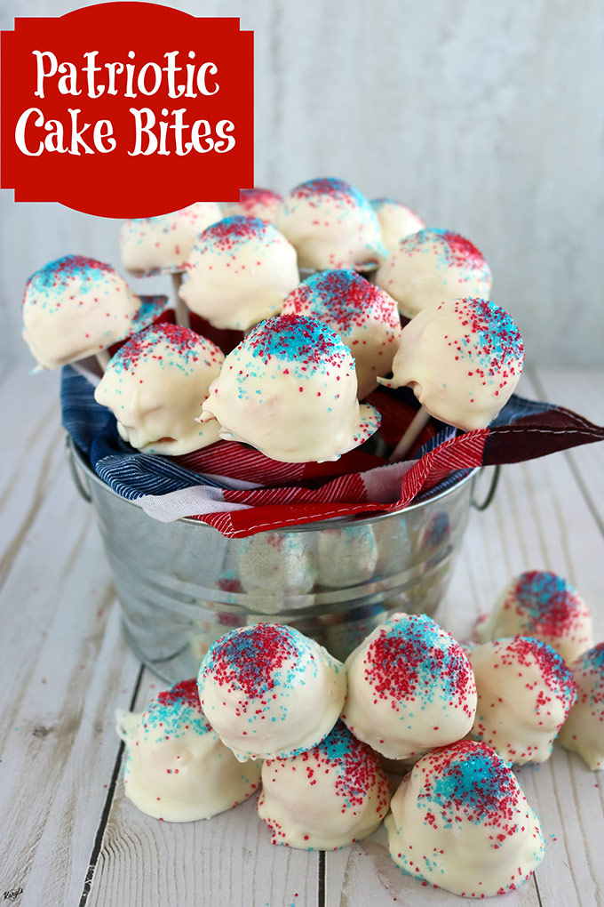 finished cake bites - some in a metal bucket on pop sticks, and some in front of the bucket