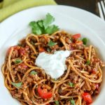 overhead angled shot of finished taco spaghetti in a white bowl