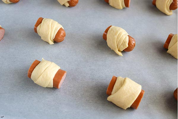 process shot: overhead shot of hot dog pieces wrapped in dough