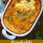 overhead shot of finished corn casserole in a white dish, with a spoon of casserole close up