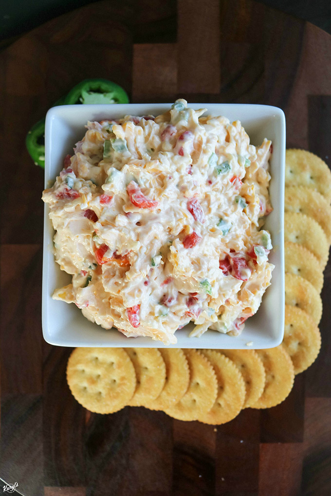 overhead shot of finished pimiento cheese in a white bowl with crackers on the side