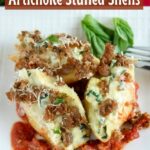 close up shot of 3 stuffed shells on a white plate