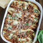 overhead shot of a baking dish with finished sausage spinach artichoke stuffed shells