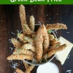 overhead shot of finished Baked Green Bean Fries in a metal bucket with a chunk of Parmesan and side of ranch