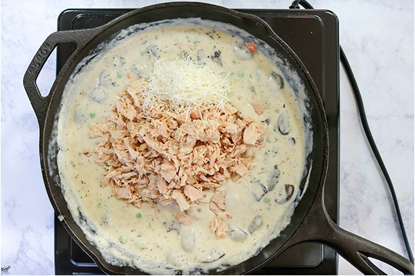 overhead process shot: tuna and Parmesan added to cream sauce mixture