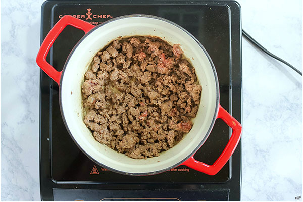 overhead process shot: venison browning in a Dutch oven