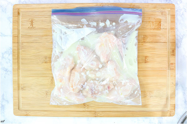 Process shot: overhead shot of chicken wings brining in a Ziplock bag