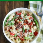 overhead shot of finished lemon ricotta fiesta pasta in a white bowl with a fork on the side