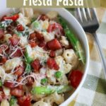 close up off center shot of a bowl of lemon ricotta fiesta pasta in a white bowl with a fork and napkin on the side