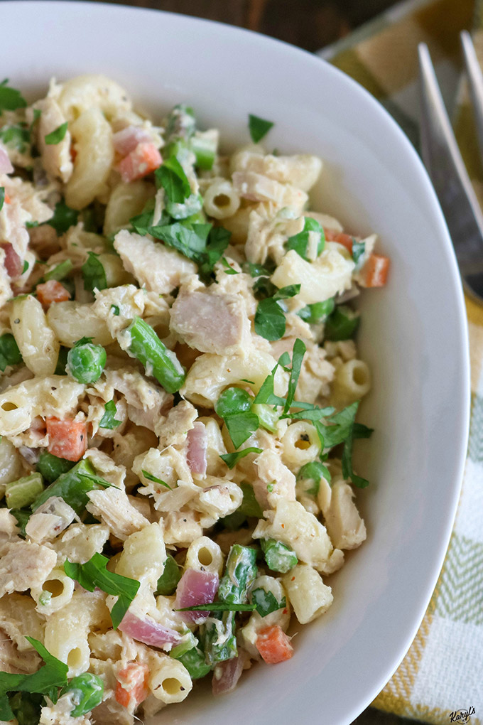 close up shot of finished tuna pasta salad in a white bowl