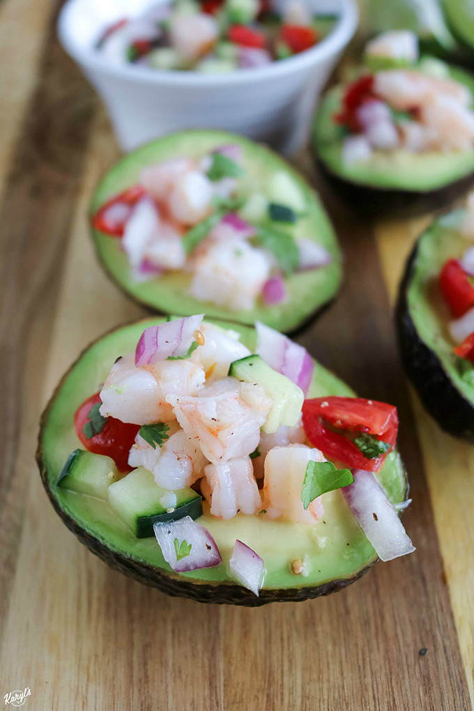 close up shot of finished avocado shrimp ceviche on a wooden board