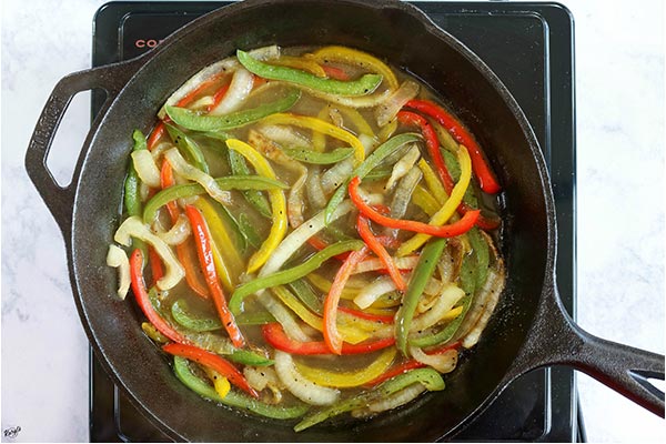 overhead process shot: veggies and beer cooking in the skillet