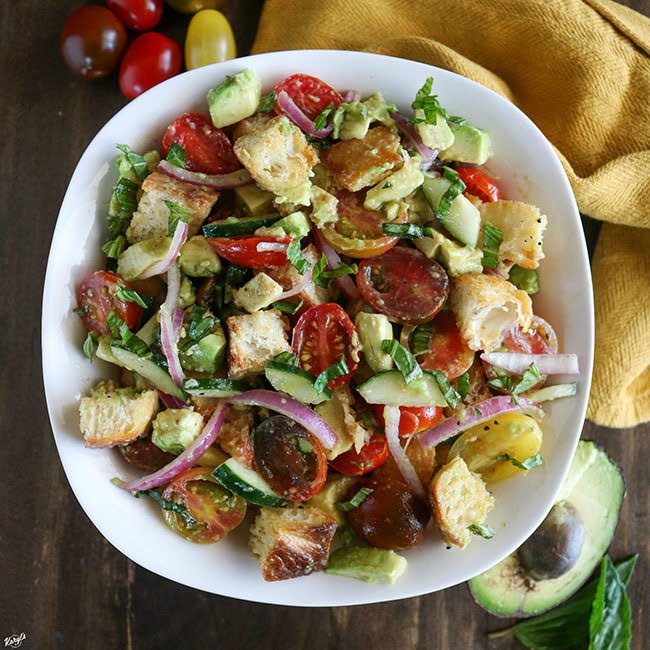 overhead shot of finished Avocado Panzanella Salad in a white bowl