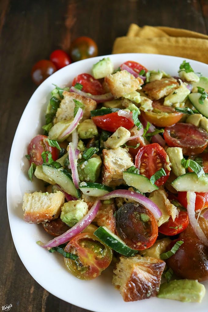 shot of finished avocado panzanella salad in a white bowl