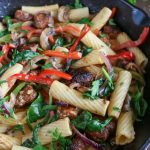 Close up shot of finished Cajun Chicken Vegetable Pasta in a cast iron skillet