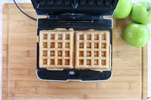 Overhead process shot of 2 waffles in a waffle iron