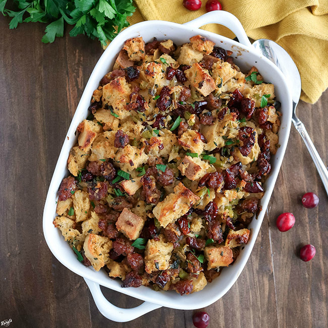 overhead shot of finished Sausage Sage Cranberry Stuffing in a white baking dish
